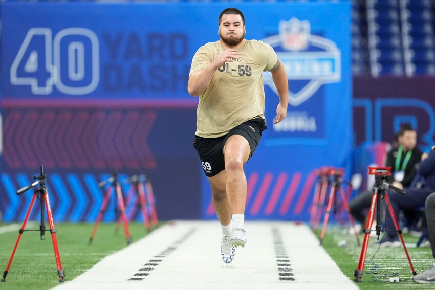 Kansas offensive lineman Dominick Puni runs a drill at the NFL football scouting combine, Sunday, March 3, 2024, in Indianapolis.