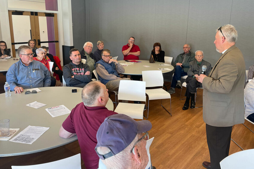 State Rep. Brad Pollitt, R-Sedalia, right, speaks at the Pettis County Pachyderm Club luncheon Friday, March 15 at the Heckart Community Center. State Rep. Rodger Reedy, R-Windsor, seated, was also on hand to give updates on this year's legislative session.   Photo by Chris Howell | Democrat