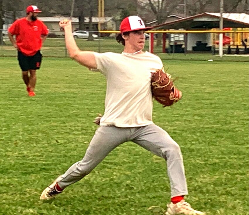 Senior Zaden Cole throws the ball during a throwing drill at Lincoln baseball practice Thursday night. Cole is the Cardinals&rsquo; only senior on the team.   Photo by Jack Denebeim | Democrat