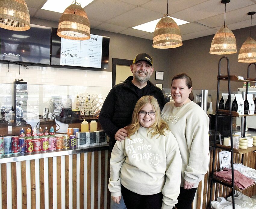 On Monday, March 18, Justin and Hilliary Hubbs, the new owners of Queen City Coffee Co., stand with their daughter Millie, 9, at the shop located at 3224 W. 16th St. The couple purchased the former Coffee Port Caf&eacute;; Queen City is now a partner with Ozark Coffee Co.   Photo by Faith Bemiss-McKinney | Democrat