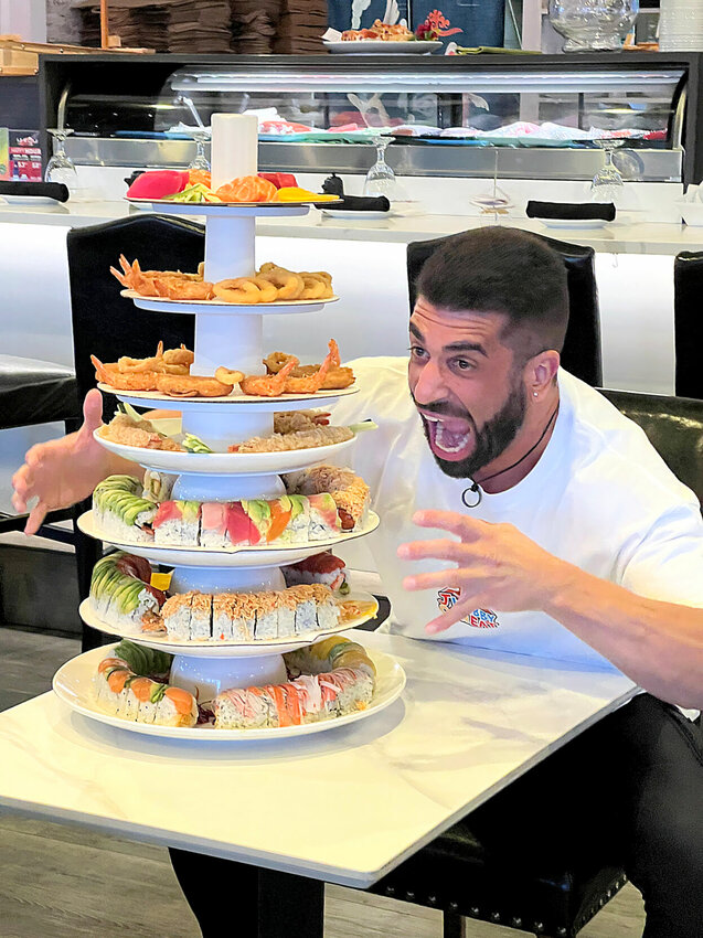 Thursday, March 28, competitive eater JWebby (James Webb), of Sydney, Australia, hams it up before polishing off a seven-layer &quot;Tower of Power&quot; at Ni-Kuni Japanese Steakhouse &amp;amp; Sushi Bar in Sedalia. JWebby is ranked No. 5 worldwide in competitive eating.   Photo by Faith Bemiss-McKinney | Democrat