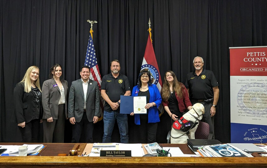 On Monday, April 1, the Pettis County Commission presented a proclamation to Citizens Against Spousal Abuse (CASA) declaring April 2024 as Sexual Assault Awareness Month. The Commission expresses full support for CASA and commits to promoting awareness and preventing sexual violence within the community, while persisting in having discussions, offering assistance, and actively striving to cultivate a secure atmosphere for all.   From left, CASA Court Advocate Bridgett Peek, CASA Director of Facility and Client Services Amanda Gaspard, Eastern Commission Israel Baeza, Presiding Commissioner Bill Taylor, CASA Executive Director Lori Haney, Therapist Joylynn Allard, Service Dog in Training Luna, and Western Commissioner Jim Marcum.   Photo courtesy of Pettis County Commission
