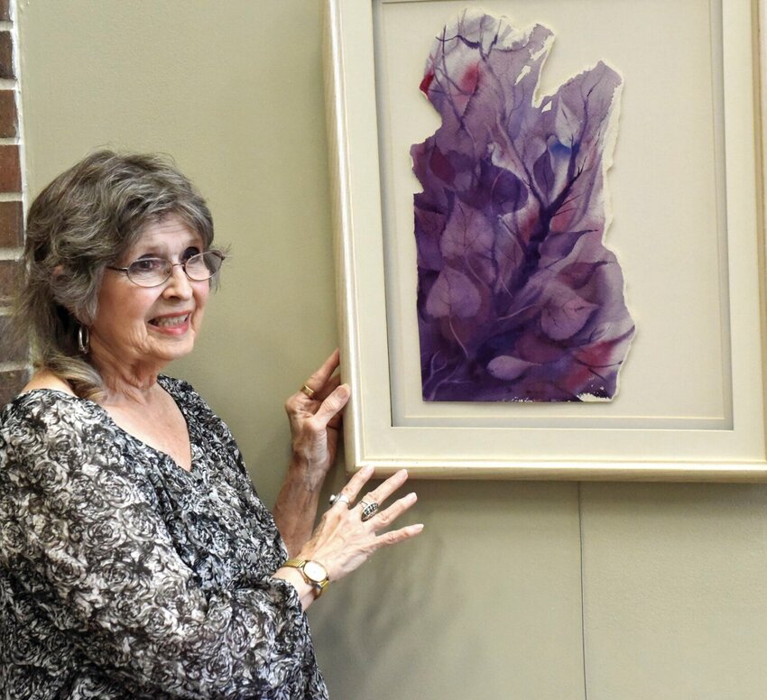 Well-known Sedalia artist Myrna Ragar stands with one of her art prices in June 2018. Ragar, who moved to Mississippi in May 2023, still enjoys giving back to the community. She recently donated work for two Sedalia Convention and Visitors Bureau billboards.   File photo by Faith Bemiss-McKinney | Democrat