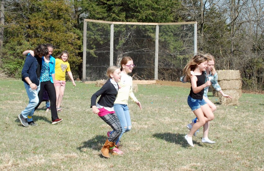 Children race to the finish line during the three-legged race as part of the Easter Bunny Hunt hosted Saturday, March 30 by Flat Creek Baptist Church in Sedalia. Other activities included sack races, a pie eating contest, an egg drop competition, spoon race, carnival games, a bounce house, an Easter egg hunt and the Easter bunny hunt.   Photo courtesy of Flat Creek Baptist Church