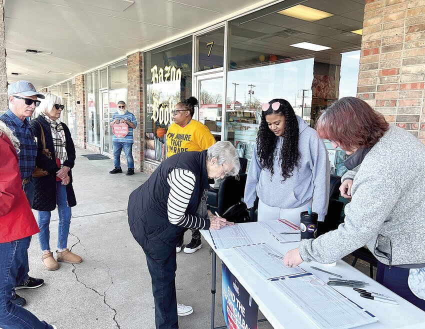 From left, Kourtney Woodbury, of Kansas City, with the Missourians for Constitutional Freedom; Heather Carlos, of Overland Park, Kansas, with Planned Parenthood; and volunteer Teresa Cicela, of Henry County, take signatures for the &quot;Right to Reproductive Freedom Initiative&quot; petition on Friday, April 5, outside Bazoo Books in Sedalia.   Photo by Faith Bemiss-McKinney | Democrat