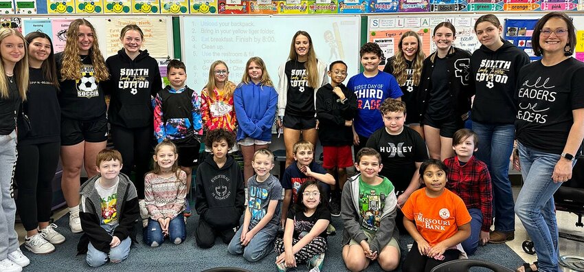 Smith-Cotton girls soccer players visit with Heber Hunt Elementary third grade teacher Susie Howe, far right, and her students. Howe received one of the team&rsquo;s mental health grants.   Photo courtesy of Sedalia School District 200