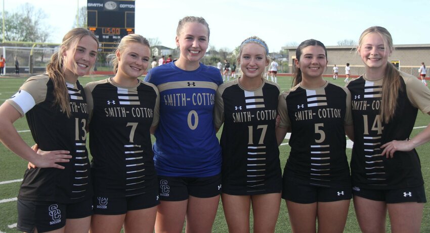 The Smith-Cotton girls soccer team seniors, from left to right, Kendall Jackson, Zoey Hieronymus, Hailey Burlingame, Adelaide Goosen, Olivia Robinson and Kennedy Woolery celebrate their senior night together before the game against Warrensburg at Tiger Stadium Tuesday.   Photo by Jack Denebeim | Democrat