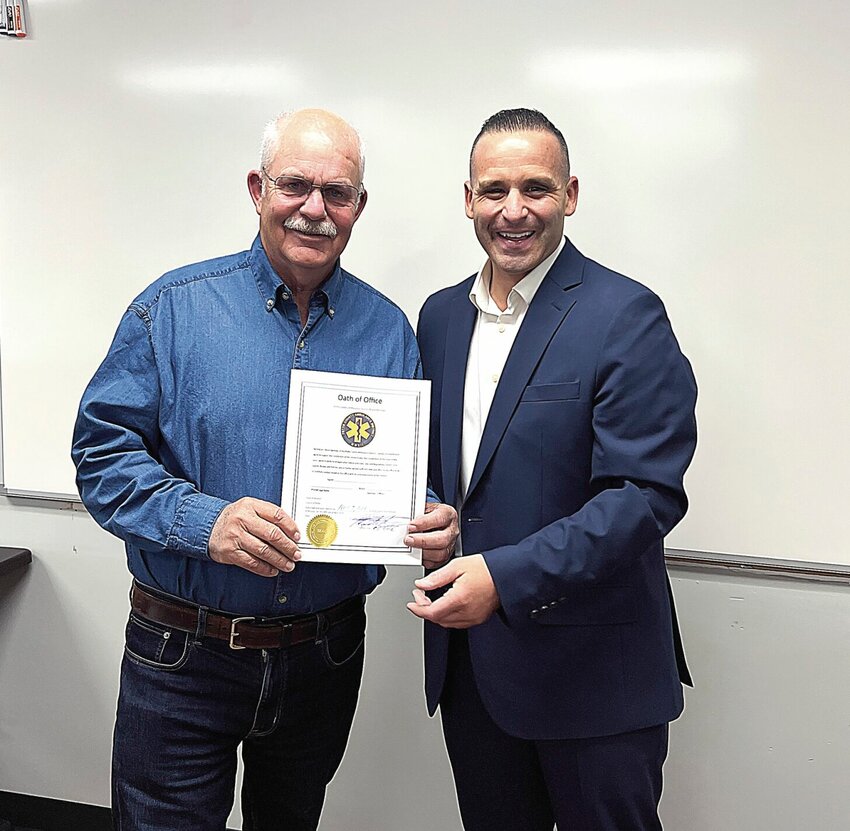 James Sneed, left, the new Pettis County Ambulance District board member for District 3, displays his oath of office with Pettis County Clerk Nick La Strada after being sworn in Tuesday night, April 9. He was elected in the April 2 municipal election. Sneed will replace Vice Chair Mike Brown, who decided not to run in 2024.   Photo by Faith Bemiss-McKinney | Democrat