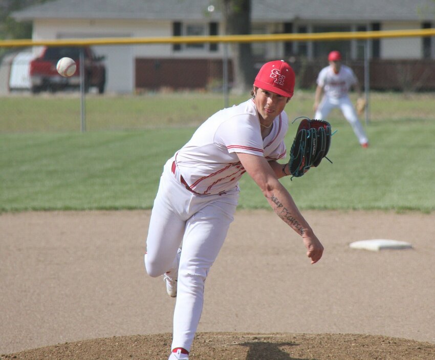 Sacred Heart senior Gavin Caldwell pitches the ball in the Kaysinger Conference Baseball Tournament semifinal game against Northwest Monday night in Lincoln. Caldwell pitched seven innings and struck out 12.   Photo by Jack Denebeim | Democrat