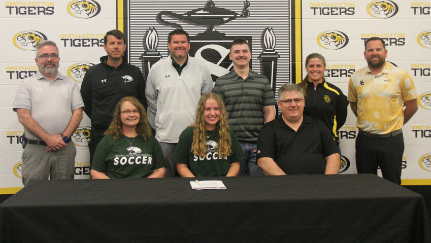 Smith-Cotton senior Hailey Burlingame celebrates signing her letter of intent to soccer at Central Methodist University with her family, Smith-Cotton administration and Central Methodist University soccer coaches.   Photo by Jack Denebeim | Democrat