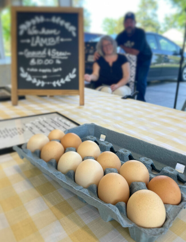 Heidi and Tim Aulgur, owners of Aulgur Livestock, display their free-range eggs at the Sedalia Area Farmers' Market on May 23, 2023. The market will open for the 2024 season on Friday, May 3 at the Nucor Pavilion on the Missouri State Fairgrounds.   File photo by Chris Howell | Democrat