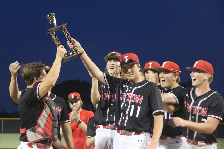 Senior Braden Fischer, right, and senior Tyler Baer hoist the Kaysinger Conference first place trophy after Tipton defeated Sacred Heart 6-4 to claim the conference title Tuesday night in Cole Camp.   Photo by Jack Denebeim | Democrat