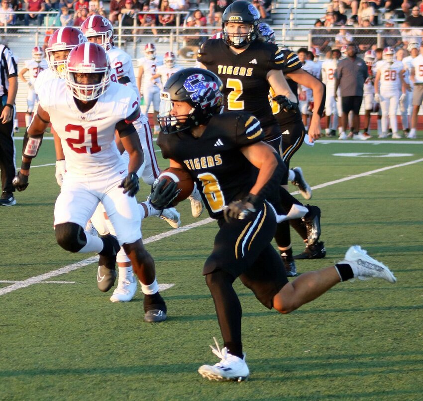 Smith-Cotton senior running back Mylan Hawkins (8) breaks to the outside on a run during S-C&rsquo;s game against Warrensburg on Sept. 8 at Tiger Stadium. Hawkins earned the 2023-24 Mark Johnson Academic Achievement Scholarship.   Photo courtesy of Sedalia School District 200
