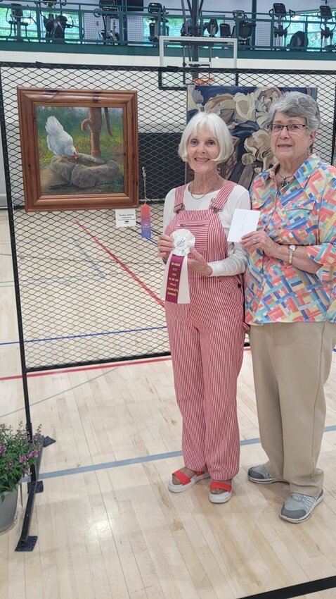 Bonnie Shelton receives the People&rsquo;s Choice Award from Mid-Missouri Artists President Rebecca Limback. Her piece, &ldquo;Hen at Her Water Trough,&rdquo; received the most People&rsquo;s Choice votes.   Photo courtesy of Mid-Missouri Artists