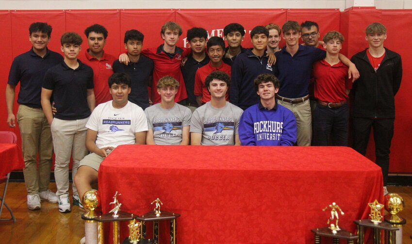 Sacred Heart seniors, sitting from left, Andres Vanegas, Traven Wheeler, George Bain IV and Jackson Manning celebrate their commitment to play soccer in college with the Gremlins boys soccer team Thursday, May 9. Manning will join Rockhurst University&rsquo;s team while Vanegas, Wheeler and Bain will join State Fair Community College.   Photo by Jack Denebeim | Democrat