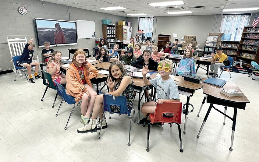 Smithton R-VI third graders wave on Wednesday, May 15, and are all smiles because they placed first in the school's Pop Tab Challenge. The students in Kadey Sartain's class collected more than 54 pounds of pop tabs to benefit the Ronald McDonald House.   Photo by Faith Bemiss-McKinney | Democrat