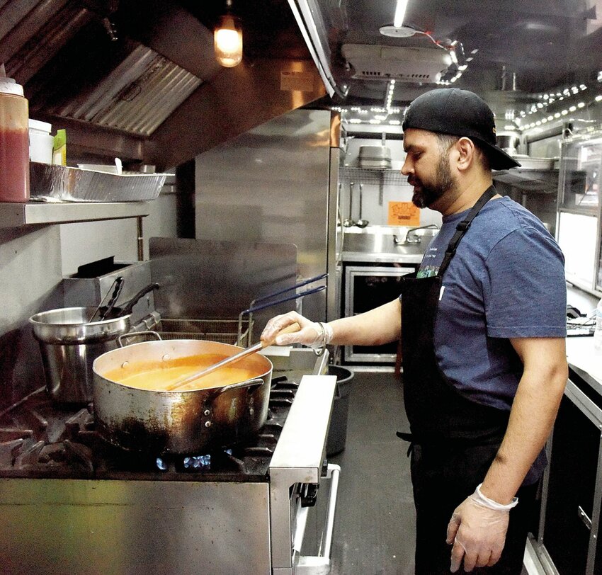 On Monday, May 20, Ravi Singh, the cook for the new food truck Taste of India, stirs a large pot of sauce for a customer favorite: butter chicken. The food truck is behind Blue Moon Smoke Shop, 1401 S. Limit Ave., and is owned by Vikas Bhardwaj and his parents, Nisha and Vijay Bhardwaj.


Photo by Faith Bemiss-McKinney | Democrat