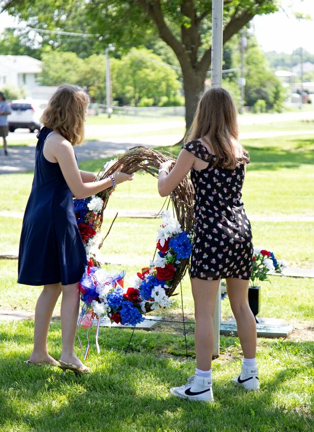 Two members of 2nd Lt. George A. Whiteman's family place a memorial wreath at his grave during the annual wreath-laying ceremony Saturday morning, May 18 in Memorial Park Cemetery in Sedalia. The event was hosted by the Sedalia Area Chamber of Commerce's Military Affairs Committee.   Photo by Nicole Cooke | Democrat