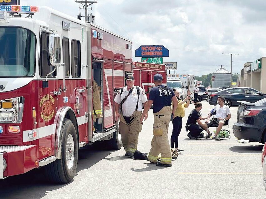 Members of the Sedalia Fire Department respond to a fire at Bella Nails &amp;amp; Spa on West Broadway Boulevard as an employee is treated for smoke inhalation Thursday afternoon, May 23.   Photo by Faith Bemiss-McKinney | Democrat