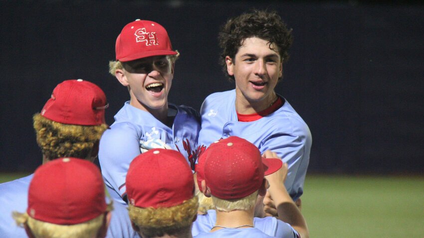 Senior Carter Rice, right, and junior Jacob Cordia celebrate Sacred Heart’s 16-6 win in the Class 1 state semifinals Monday, May 27, as the dugout storms the field. Rice hit a walk-off bases-clearing triple to end the game via the 10-run mercy rule.


Photo by Jack Denebeim | Democrat