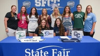 State Fair Community College softball players, sitting, from left to right, Sami Picha and Paige Klinge celebrate signing their letters of intent with members of the Lady Roadrunners softball team on May 17.   Photo courtesy of State Fair Athletics