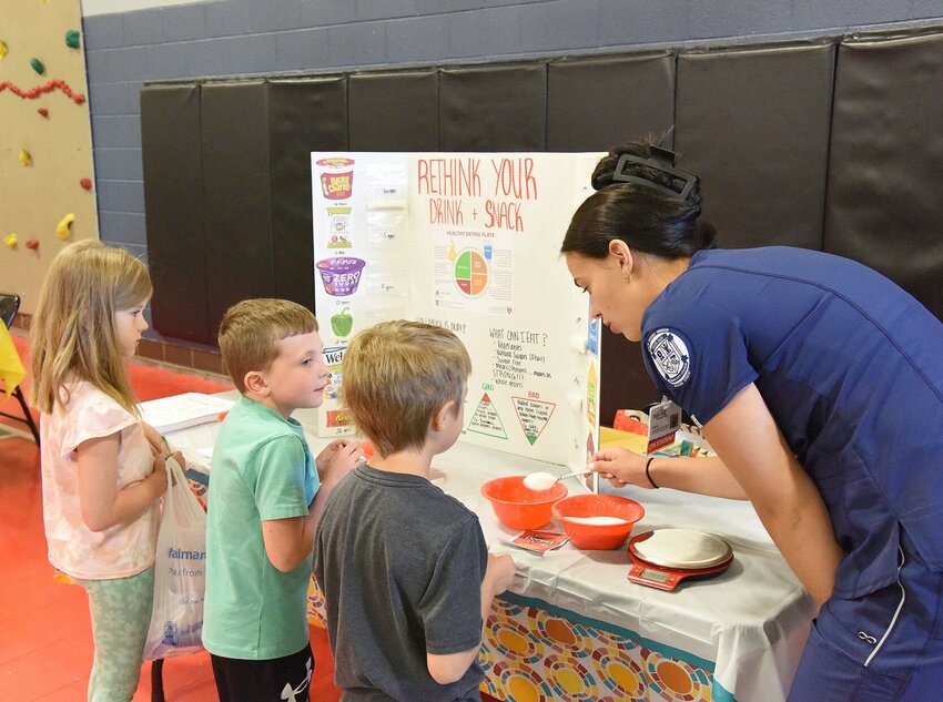 On Wednesday, June 19, during the State Fair Community College Health Fair, nursing student Genae Hodge shows a spoonful of sugar to members of the Boys &amp;amp; Girls Clubs of West Central Missouri. Hodge's table was about &quot;Rethink What You Drink and Eat.&quot; The annual event is hosted each year for the Boys &amp;amp; Girls Club. This year it was hosted at Heber Hunt Elementary School.   Photo by Faith Bemiss-McKinney | Democrat