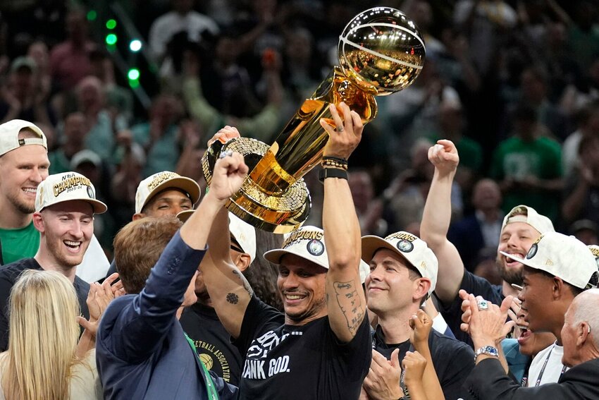 Boston Celtics head coach Joe Mazzulla, center, celebrates with the team as he holds up the Larry O'Brien Championship Trophy after they won the NBA basketball championship with a Game 5 victory over the Dallas Mavericks, Monday, June 17, 2024, in Boston.   Photo by Charles Krupa | AP Photo
