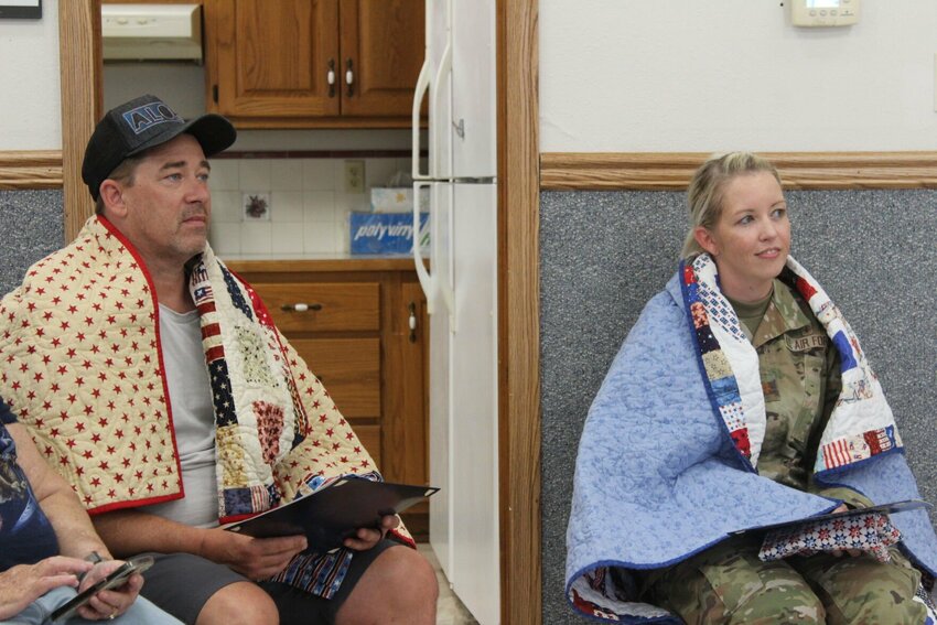 Retired Master Sgt. Thomas Nevins and Major Jackie Beach sit and listen to the presentation after receiving their quilts on Thursday, June 27, at the Knob Noster United Methodist Church. Nevins served in the U.S. Air Force from 1990 to 2012, while Beach is currently active duty at Whiteman Air Force Base.&nbsp;   Photo by Zach Bott | Star-Journal