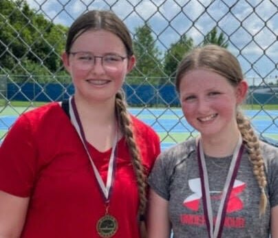 Natalie Beard, left, and Gretchen Beard celebrate winning the doubles tournament of the Summit Slam series at the KC Summer Slam Tuesday, July 9. The duo won their three matches 8-1, 8-2 and 8-0.   Photo courtesy of the KC Summer Slam