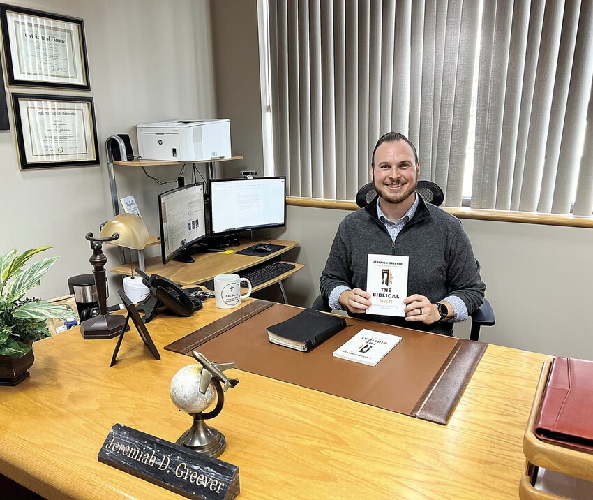 On Thursday, July 18, Senior Pastor Jeremiah Greever of First Baptist Church holds his newly published book, &quot;The Biblical Man: Becoming the Man God Made You to Be,&quot; which encourages men to thrive and be successful on God.   Photo by Faith Bemiss-McKinney | Democrat