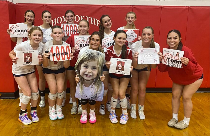 Sacred Heart senior Avery Epple, center, celebrates reaching 1,000 career assists with her teammates Thursday, Oct. 3. As of Monday, Oct. 7, Epple ranked eighth in Class 2 in assists this season.   Photo courtesy of Sacred Heart volleyball