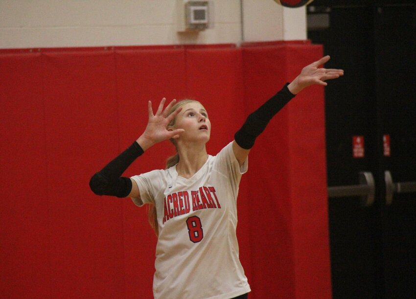 Sacred Heart freshman Addison Figge serves the ball during the match against Lincoln Tuesday, Oct. 8.   Photo by Jack Denebeim | Democrat