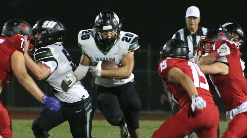 Warsaw senior Jayce DePriest (20) hits the hole during the game against Butler on Oct. 11. DePriest scored four touchdowns in the Wildcats&rsquo; 39-0 win over Sarcoxie Friday, Nov. 8.   Photo by Adam Howe | Benton County Enterprise