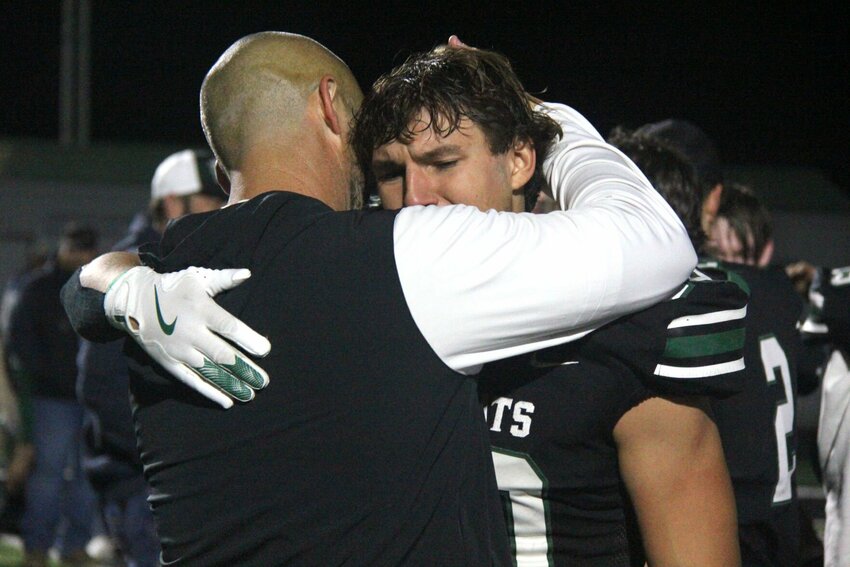 Warsaw senior Jayce DePriest, right, hugs head coach Ryan Boyer after the Wildcats&rsquo; 15-13 loss to Lamar in the Class 2 District 5 championship game Friday, Nov. 15. Warsaw finishes the season with a 10-1 record.   Photo by Jack Denebeim | Democrat