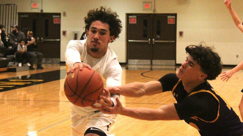 Smith-Cotton senior Jakobe Linn, left, intercepts a pass from a Camdenton player during the game on Wednesday, Jan. 8, at Smith-Cotton High School. The Tigers held Waynesville to just two points in the fourth quarter to earn a 55-40 win Friday, Jan. 17.   File photo by Jack Denebeim | Democrat
