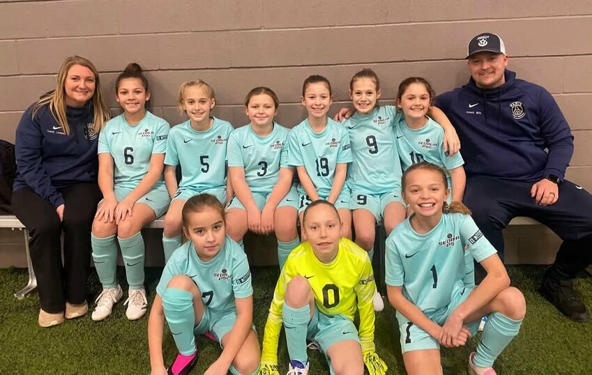 The Sedalia Select PSG girls soccer team celebrates taking first place in the Heartland Indoor Soccer League and finishing the season 8-0. The team is coached by Billy Grose and Lindsay Cornell.   Photo courtesy of Sam Jones