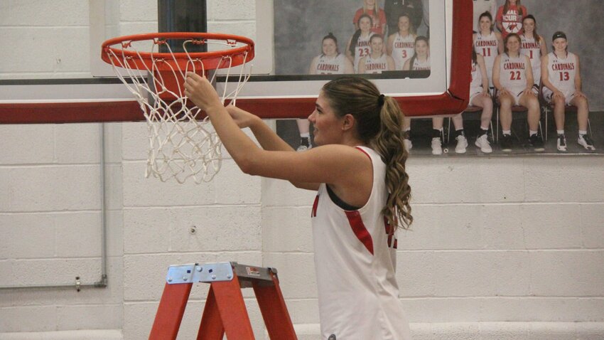 Tipton junior Ava Schlotzhauer cuts down the net after the Lady Cardinals defeated Clopton in the Class 2 state quarterfinals on Saturday, March 8, at Tipton High School.   Photo by Jack Denebeim | Democrat