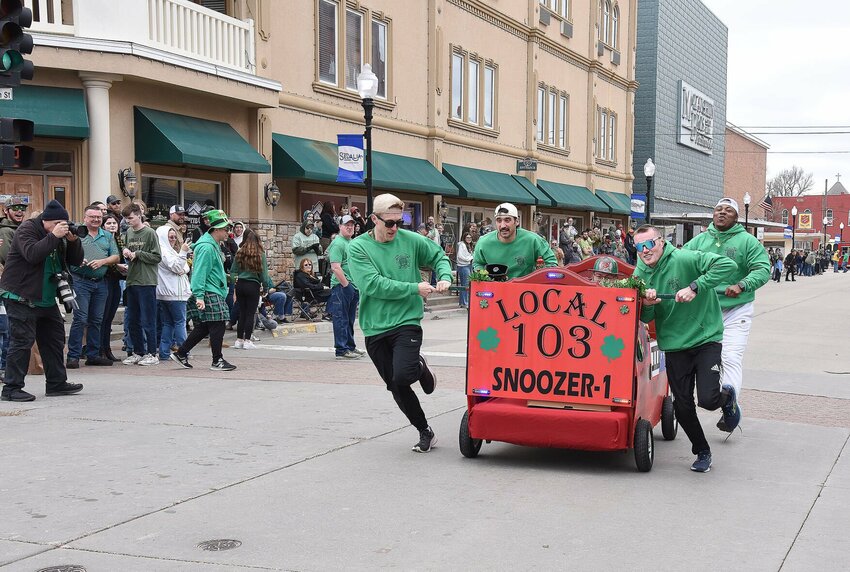 Sedalia Firefighters Local 103 cross the finish line on Saturday, March 15, during the St. Patrick&rsquo;s Day festivities in downtown Sedalia. The firefighters went on to win first place and $200. The day was filled with a parade, the bed races sponsored by the Sedalia 103, and a pub crawl sponsored by the Sedalia Lions Club.   Photo by Faith Bemiss-McKinney | Democrat