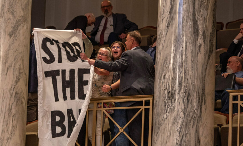 Missouri Senate security shuts down protestors with a “stop the ban” banner in the Senate’s upper gallery Wednesday evening.