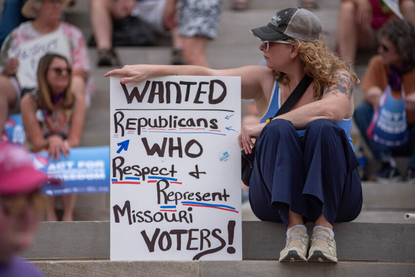 Jen Kruse, from Tipton, holds up a sign in protest of the Missouri State Legislature's decision to pass legislation to overturn voters' recent ballot measures. "I wish reason would take over," she told The Independent. (Annelise Hanshaw/Missouri Independent).