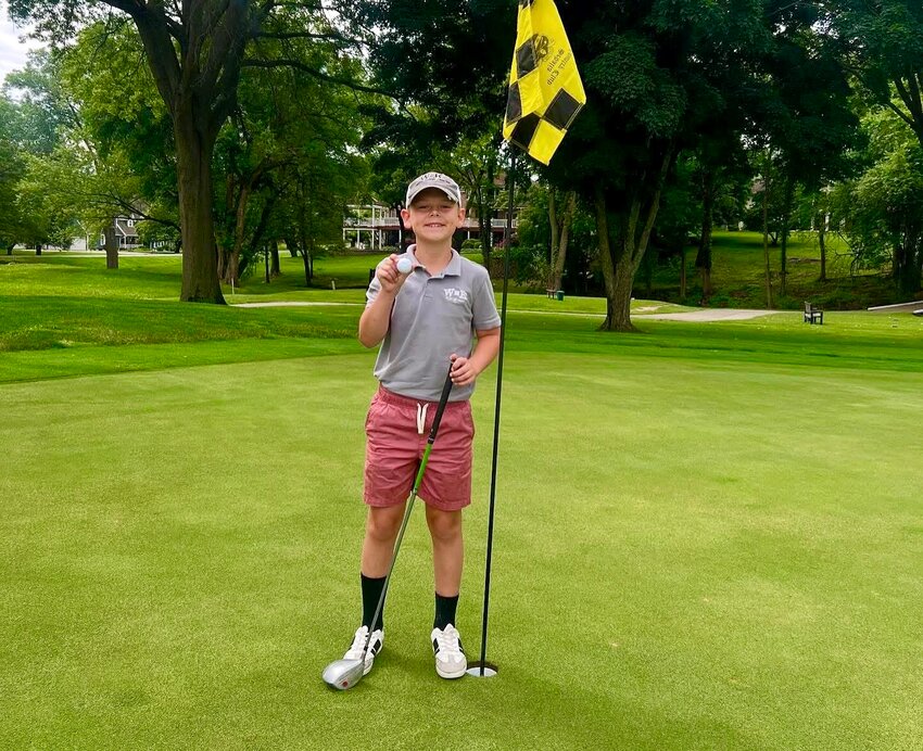 Kellen Weymuth, 10, celebrates hitting a hole-in-one on hole 14 at Sedalia Country Club on Friday, June 6.