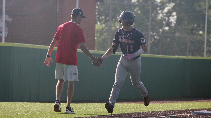 Sedalia Post 642 Travelers utility player Jayden Archibeque, right, celebrates with head coach Tanner McKee after hitting a home run during a game against Raymore Wheelhouse on June 9. Archibeque, McKee and the Travelers host the Bill Dey M