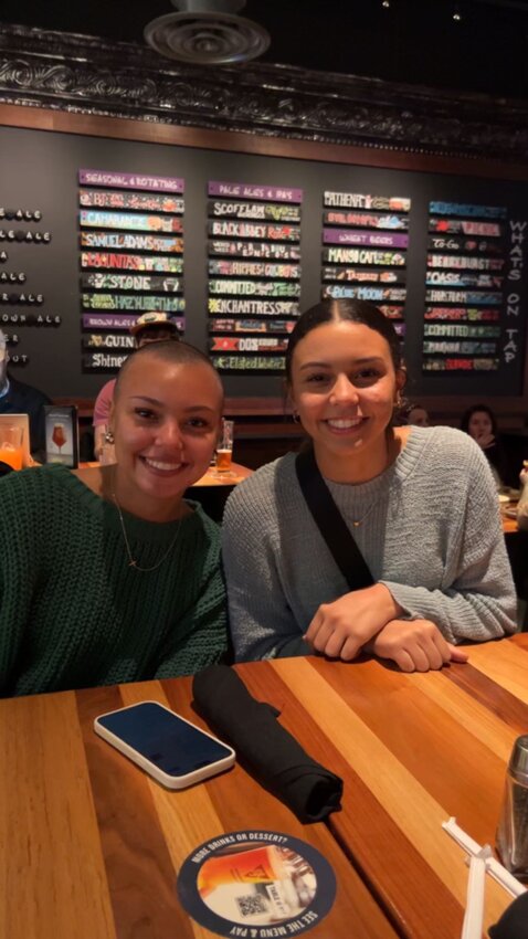 Alyvia Smith (left) with her sister Alyssa (right) after losing her hair.