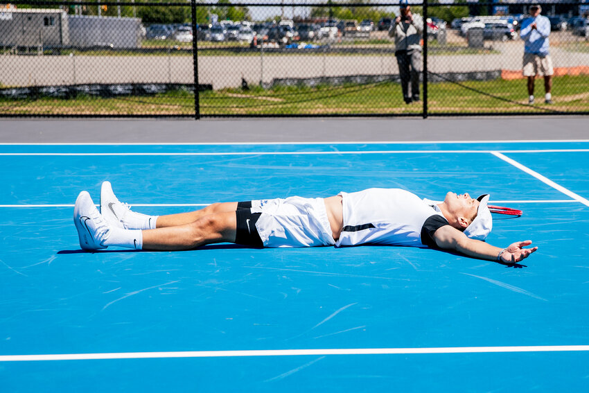 Jakub Kroslak collapses to the court after winning Sunday's clinching point.