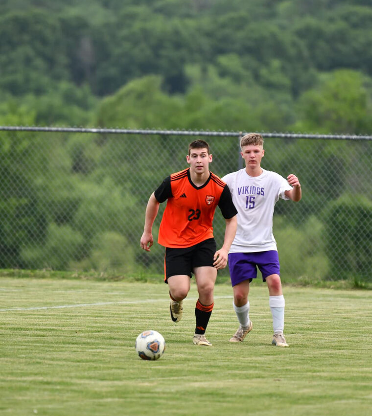 Isaac Chapa (23) and Clayton Dodson (15) both fight to win back possession.