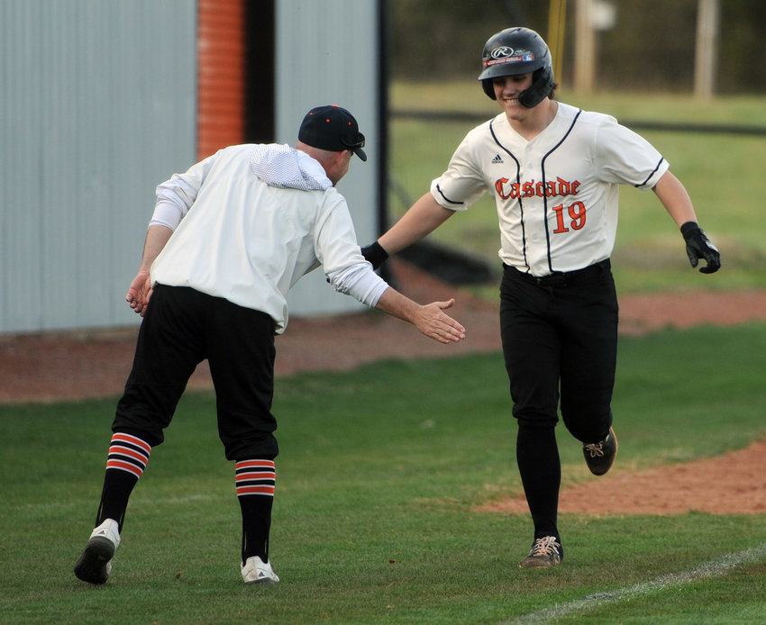 Sawyer Lovvorn catches a five from Champion coach Josh Hammonds after going yard on Monday against Cornersville.