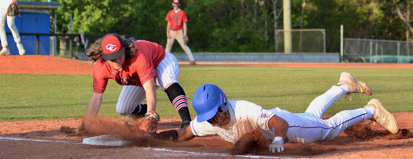 Kyler Trice safely dives back to first base against Coffee County on Thursday night.