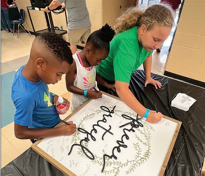 Students attending last Saturday&rsquo;s Back-to-School bash at Harris Middle signed this &lsquo;thank you&rsquo; to those responsible for organizing the fun event