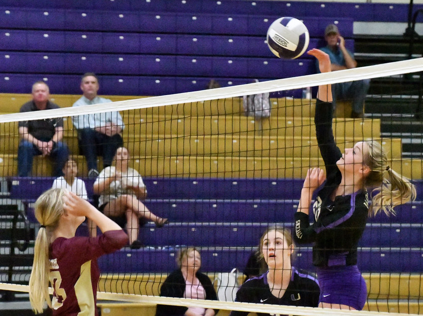 Paige Simmons (20) gets the winner at the net for the Viqueens. Simmons had four kills in the Community win.