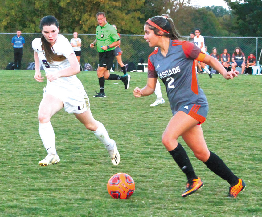 Abby Lamb (2) looks for an open teammate as Addison Brothers (9) closes in on defense.